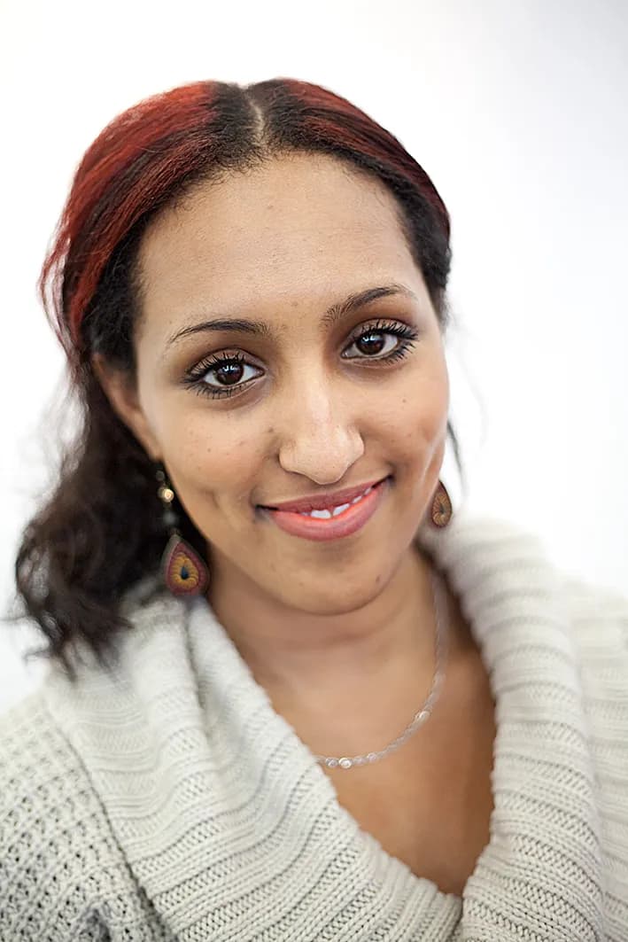 Clean professional headshot against a neutral background with natural confident expression