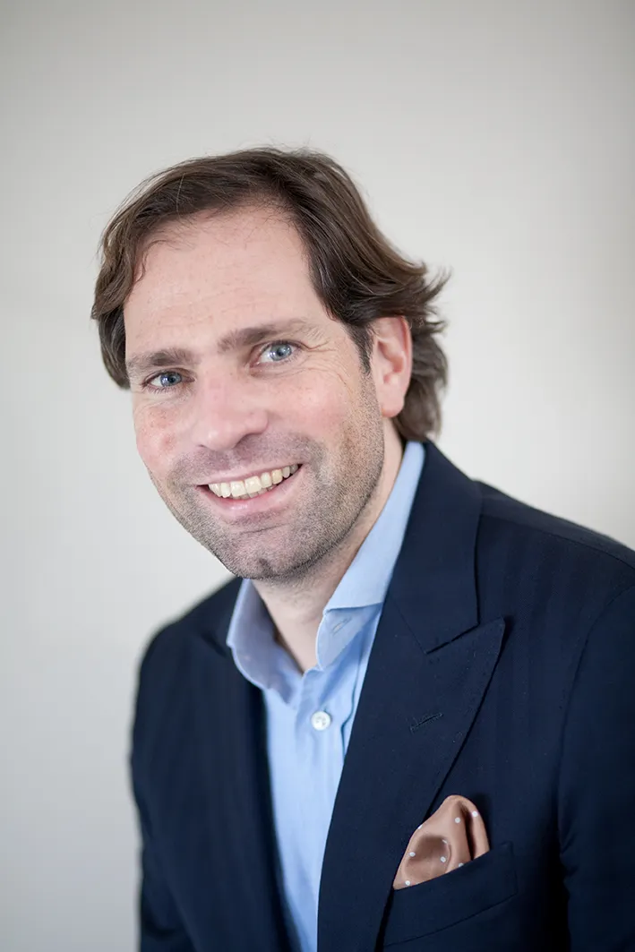 Professional headshot with natural expression and soft studio lighting on a clean background